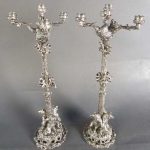 Pair silver over bronze candelabras with sculpted monkeys and bears