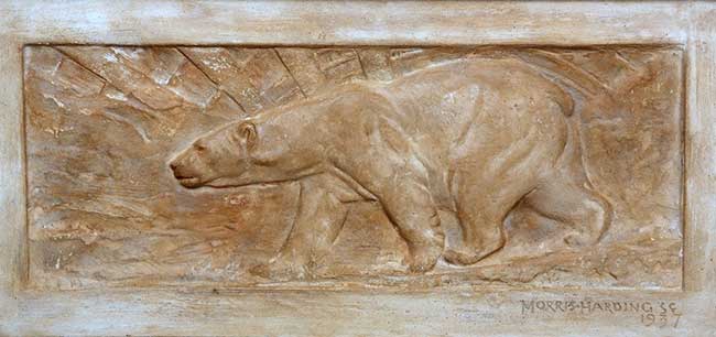 AN EARLY 20TH CENTURY RELIEF MOULDED PLASTER PLAQUE OF A POLAR BEAR