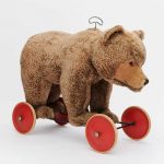 A LIFE SIZED STEIFF PLUSH MOHAIR 'RIDE ON' GROWLER BEAR ON WHEELS Circa 1950